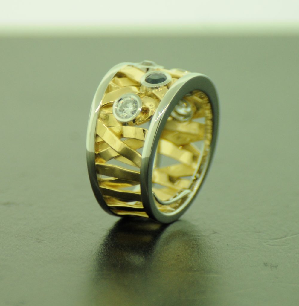 Side profile of yellow and white gold ring with diamond and sapphire By Marcus Ó Broin Jewellery, Kelowna, BC.