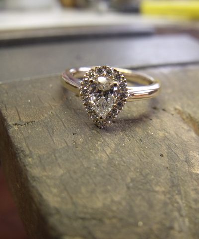 Pear shape diamond with halo setting in pink gold. By Marcus Ó Broin Jewellery, Kelowna, BC