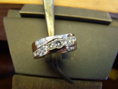 Bead set diamonds set at a diagonal along the top of a white gold band By Marcus Ó Broin Jewellery, Kelowna, BC.