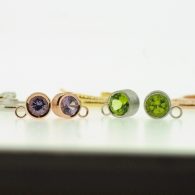 Peridot and spinel bezel set in white and red gold earrings By Marcus Ó Broin Jewellery, Kelowna, BC.
