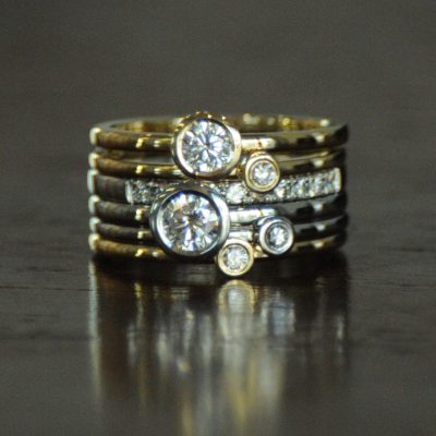 Bezel set white and yellow gold stacking diamond rings. By Marcus Ó Broin Jewellery, Kelowna, BC