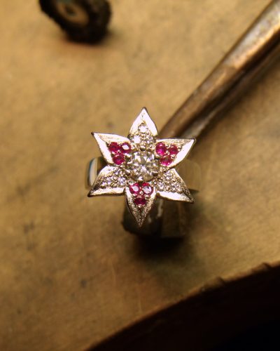 Six petals set with diamonds and rubies made in yellow and white gold. By Marcus Ó Broin Jewellery, Kelowna, BC